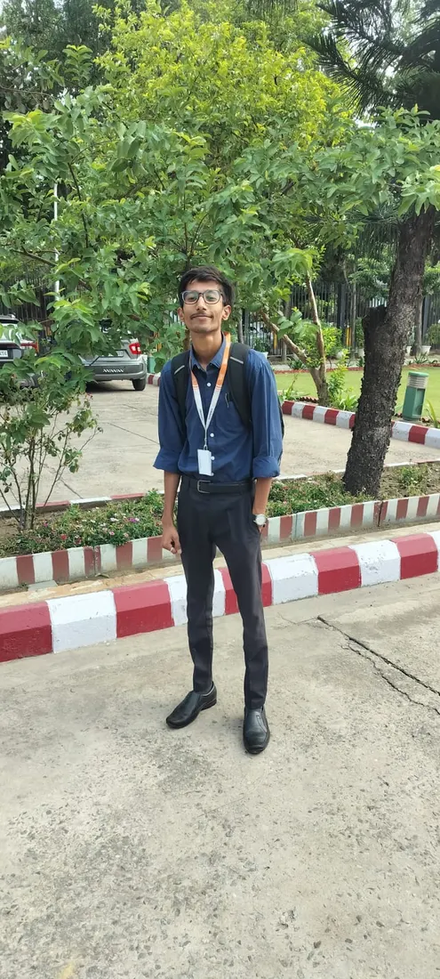 Sarwang Shukla in formal wear with an ID badge